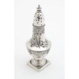 A Victorian silver pepperette of urn shape on squared foot. Hallmarked Birmingham 1896 maker