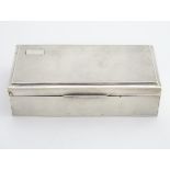 An Art Deco silver table top cigarette box. Hallmarked Chester 1934 maker E J Trevitt & Sons. 7 1/4"