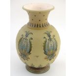 A Mettlach vase with a flared rim and bulbous body, decorated with sylised floral and foliate motifs