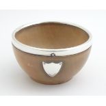 Treen : A turned sycamore wood bowl with silver rim and shield hallmarked London 1927 maker F & C