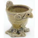 A novelty stoneware egg cup modelled in the style of a Martin Brothers' wally bird. Approx. 2" high.