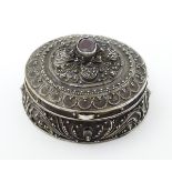 A 925 silver pill box of circular form with red stone detail to top. ½" diameter Please Note - we do