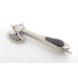 A silver brooch formed as an axe set with Scottish hardstone detail. 1 1/2" long Please Note - we do