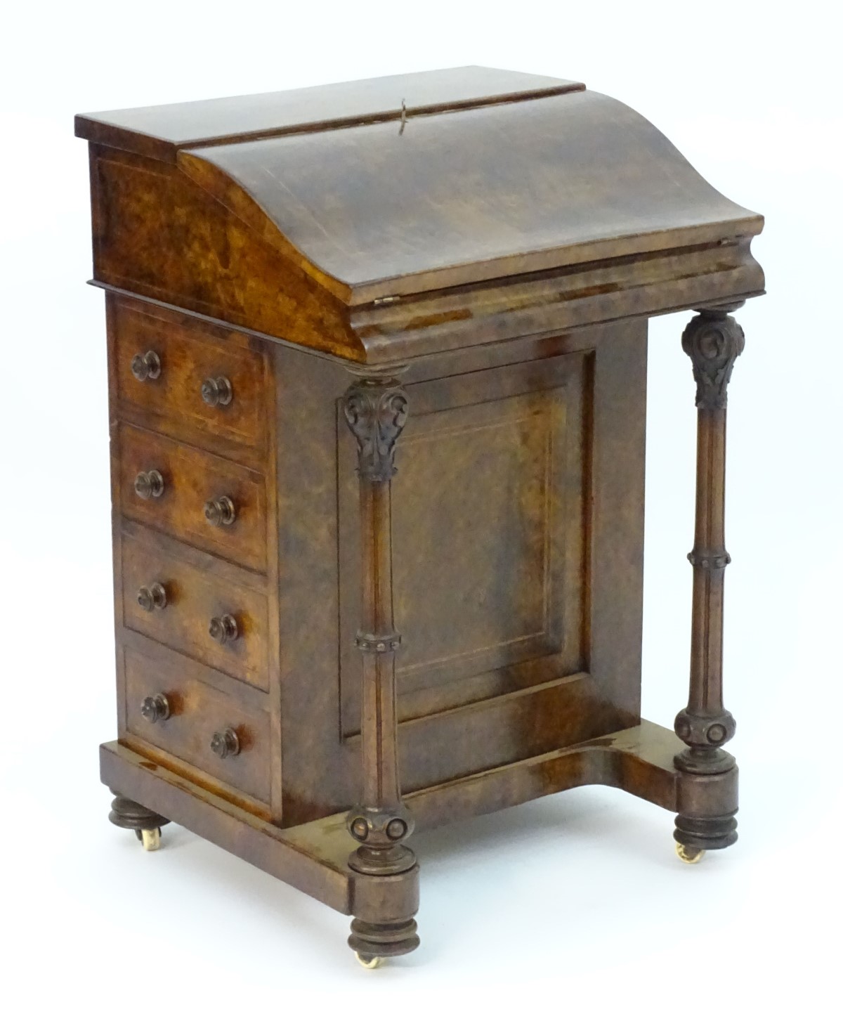 A mid 19thC burr walnut davenport with cross banding and decorative stringing, the top opening to