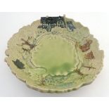 A locally crafted studio pottery bowl with a shaped rim, decorated in relief with countryside