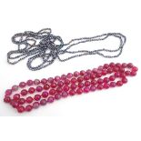 A retro fuchsia coloured quartz bead necklace 46" long together with two long pearl necklaces approx