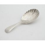 A silver caddy spoon with scallop shell bowl. hallmarked Sheffield 1926 maker Aitkin Bros 3 1/2"