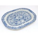 A 19thC blue and white tree and well meat plate, with panelled decoration depicting figures on