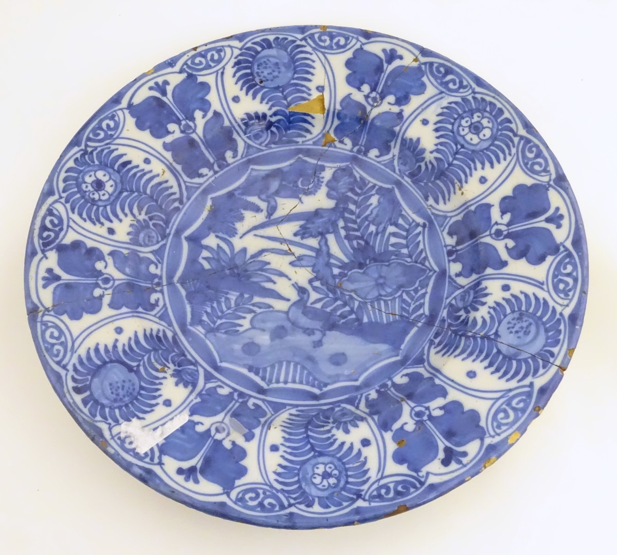 A blue and white Chinese Export Kraak style charger, with panelled decoration depicting stylised