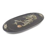 An oval lacquered pin dish with inlaid abalone decoration depicting a stylised dragonfly with