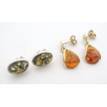A pair of silver earrings set with amber cabochon together with silver gilt drop earrings set with