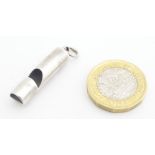 A white metal whistle 1" long Please Note - we do not make reference to the condition of lots within