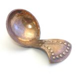 An Arts & Crafts Keswick School copper caddy spoon with hammered decoration. Stamped for Keswick