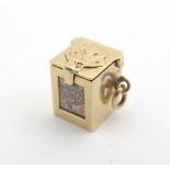 A 14 kt novelty pendant charm formed as a box containing miniature playing cards. Approx 1/2" high