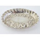 A Victorian silver pin tray with embossed decoration hallmarked London 1883 maker Holland, Son &