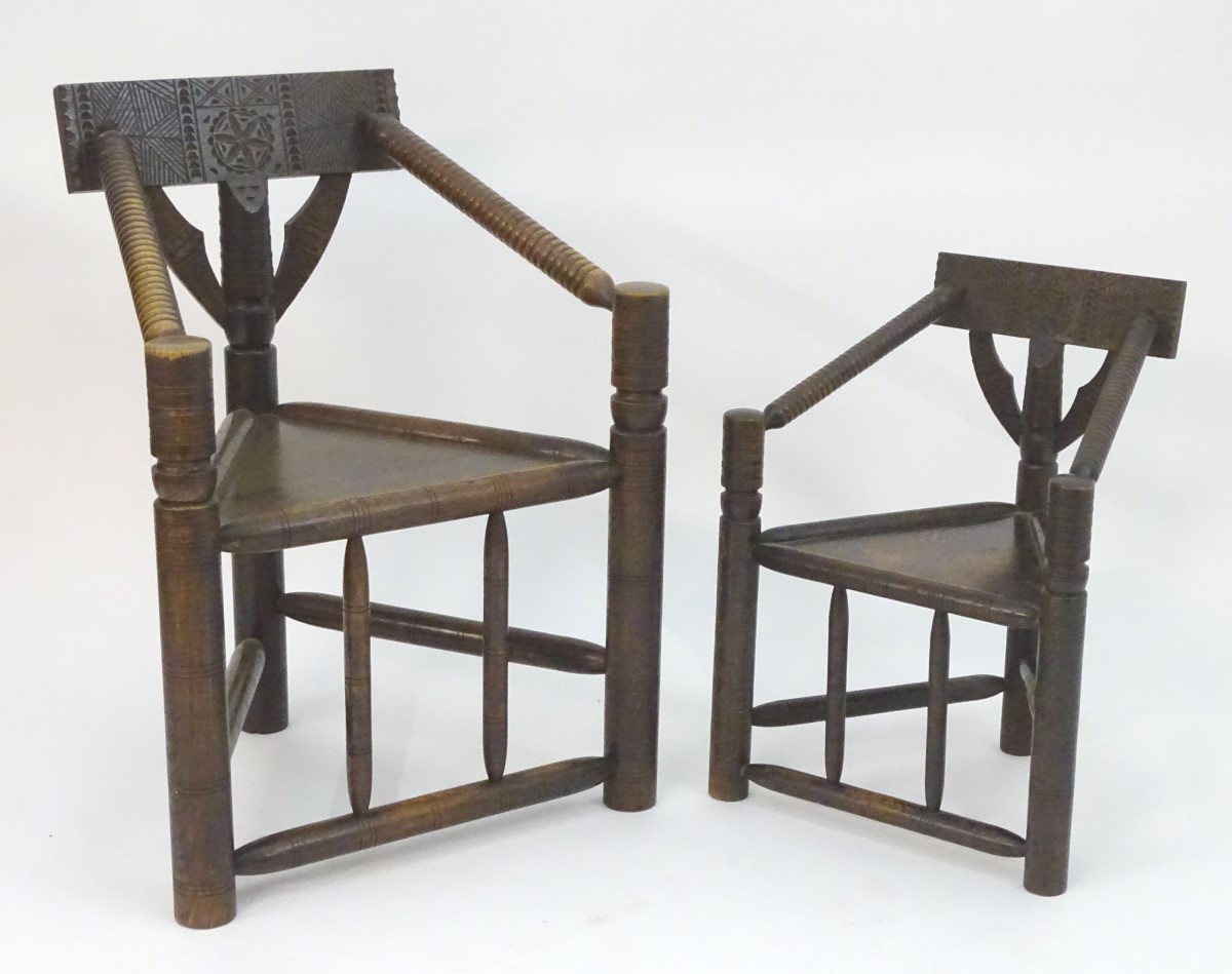 Two 19thC oak turners chairs with carved top rails, incised brackets and bobbin turned arms, the