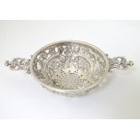 A Victorian silver strainer with pierced decoration and twin handles . Hallmarked Birmingham 1894