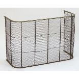 An early 20thC nursery fender with a mesh surround and brass top. 36'' long x 24'' high Please