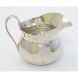 A silver cream jug hallmarked London 1939 maker Edward Barnard & Sons Ltd. 3" high (90g) Please Note