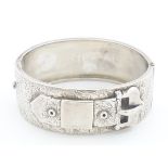 A Victorian silver bangle formed bracelet with buckle decoration. Hallmarked Birmingham 1882