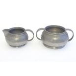 An early 20thC pewter milk jug and sugar bowl designed by Archibald Knox for the Tudric range by