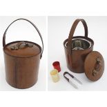 Kitchenalia: A 20thC ice bucket, the brown leather outer with carrying handle and brass fitments,