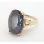 A 14kt gold ring set with large mystic topaz, approx 3/4" x 1/2" Please Note - we do not make