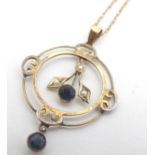 A 9ct gold pendant and chain, the pendant set with blue stone and seed pearl detail Pendant 1 1/2"