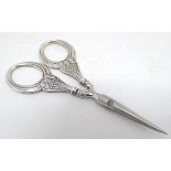 A pair of Continental white metal handled scissors 4 1/4" long Please Note - we do not make
