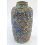 An Oriental vase with hexagonal panelling depicting landscapes, and flowers with scrolling