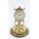 A mid 20thC 'Kundo' anniversary clock with a glass dome above a brass frame. 12" high. Please Note -