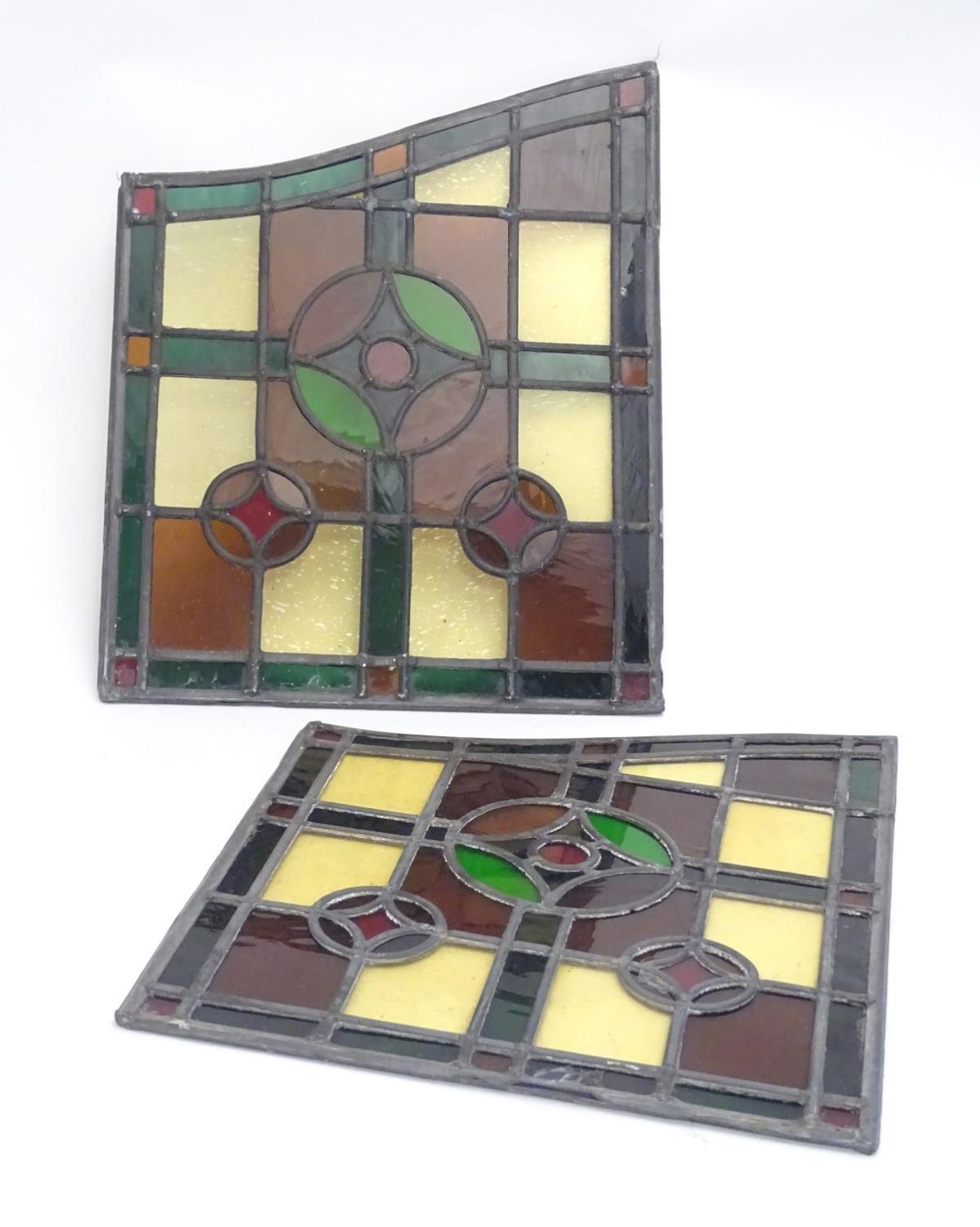 A pair of early 20thC lead and stained glass window / door panels, of irregular quadrilateral