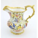 A Hammersley & Co. Queen Anne jug decorated with flowers and foliage, with gilt rims and handle.