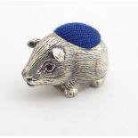 A white metal novelty pin cushion formed as a guinea pig. Approx. 1" long Please Note - we do not
