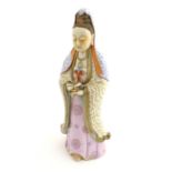 A Chinese famille rose standing figure of Guanyin, the Buddhist bodhisattva associated with