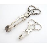 Two white metal sugar nips, one 5 1/2" long the other 3" long (2) Please Note - we do not make