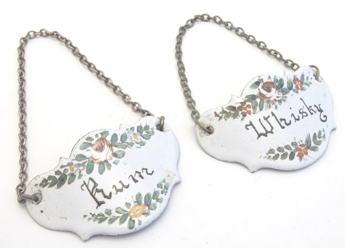 Two French enamel decanter labels for Whisky and Rum, with floral decoration. Ascribed France verso.