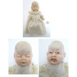 Toy: A bisque doll with two faces: one sleeping and one crying, with articulated arms and legs,