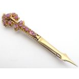 A yellow metal turban pin / brooch set with a profusion of rubies, Probably Indian gold. 3 1/4" long