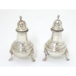 A pair of pepperettes hallmarked Birmingham 1921 maker Edward Barnard & Sons Ltd. 3 1/2'' high