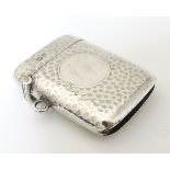 A silver vesta case with hammered decoration, hallmarked Chester 1906 maker E J Trevitt & Sons 1 3/