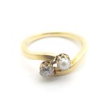 A yellow metal ring set with diamond and pearl ( Unmarked tests as 18ct) Ring size approx J Please