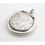 A small silver compact of circular form with engraved decoration and mirror to lid. Maker G F