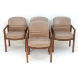 A set of four Gordon Russell armchairs with show wood frames and leather upholstered backrests and