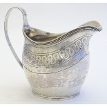A silver helmet shaped cream jug hallmarked London 1808 maker William Bennett. 4 1/2" high (126g)