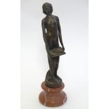 A late 20thC spelter figure depicting an Art Nouveau style woman, raised on a composite base.