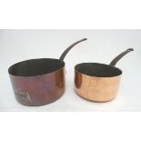 Two 19thC copper cooking pots, each having cast iron handles with hanging loops, the smaller stamped