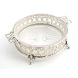 A silver butter / preserve dish with twin handles and glass liner, The frame with geometric openwork