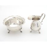 A silver cream jug and sugar bowl hallmarked Birmingham 1916 Maker Henry Williamson Ltd. the jug 3