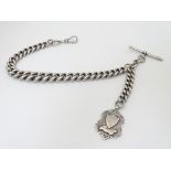 A large, heavy Victorian silver watch chain with T bar and large silver fob (probably for a